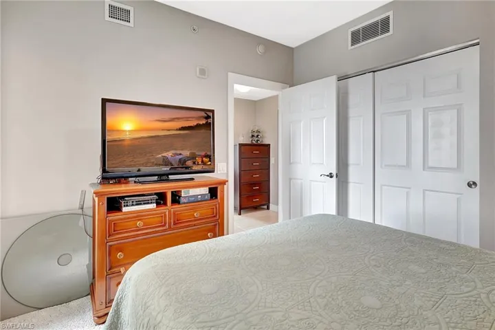 Tiled bedroom featuring a closet