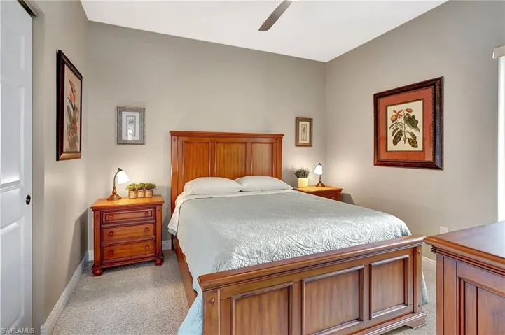 Bedroom featuring light carpet and ceiling fan