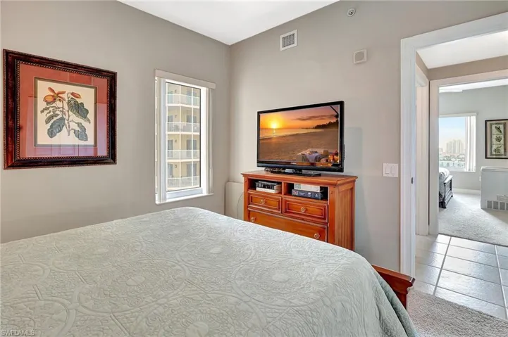 Bedroom featuring light carpet