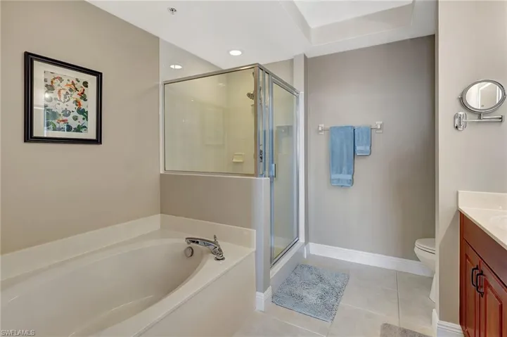 Full bathroom featuring vanity, tile patterned floors, independent shower and bath, and toilet