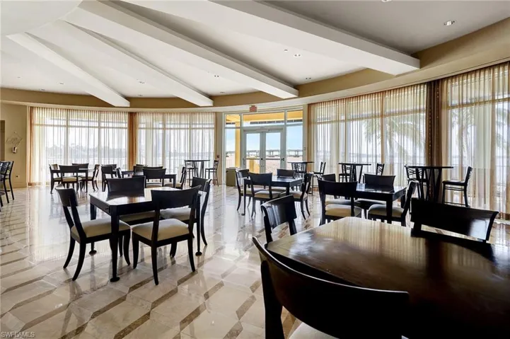Common area with french doors and beamed ceiling