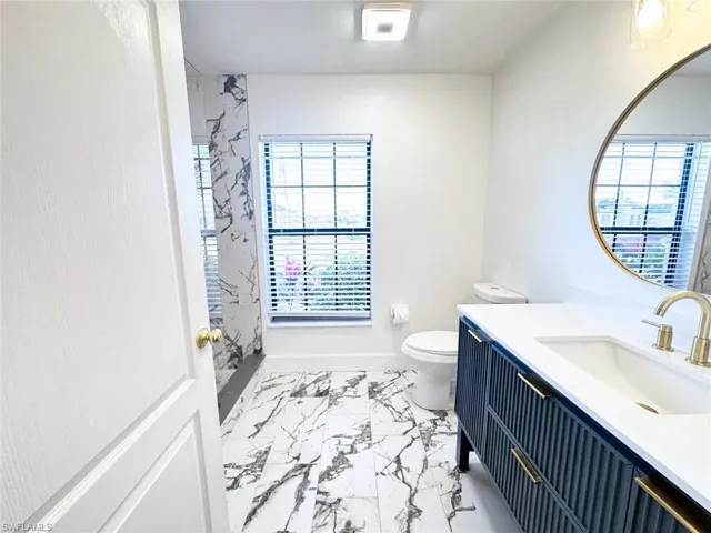 Ensuite bathroom featuring custom tile work and vanity, new toilet (2024).