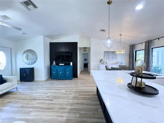 Living area connecting to kitchen and dining