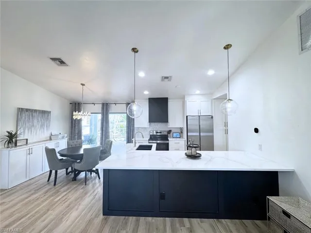 Kitchen featuring stainless steel appliances with new cabinetry