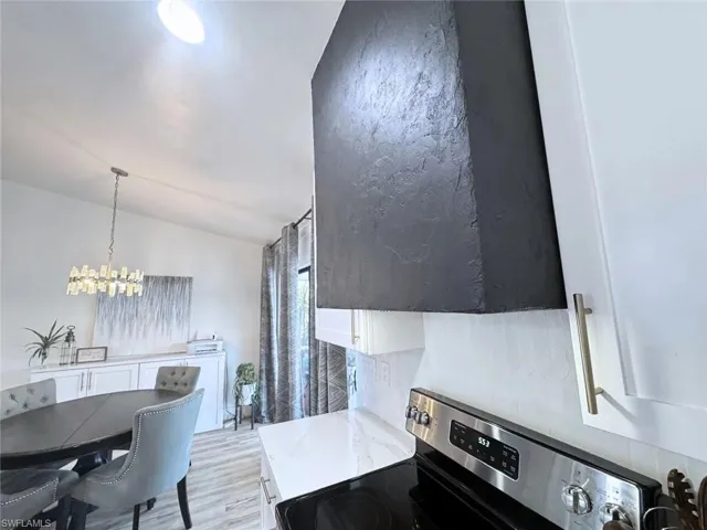 Italian plaster range hood, individually hand-laid tile backsplash