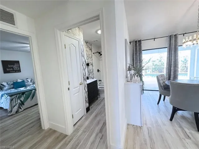 Corridor connecting open living space to bedrooms and bathroom