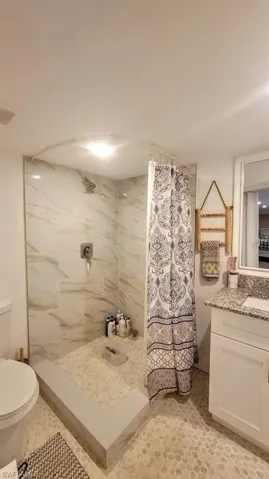 Bathroom with a shower stall and vanity