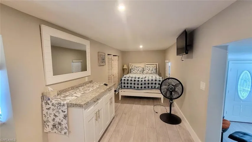 Bedroom with light wood finished floors and recessed lighting
