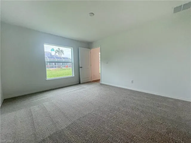 Spare room with carpet flooring and baseboards