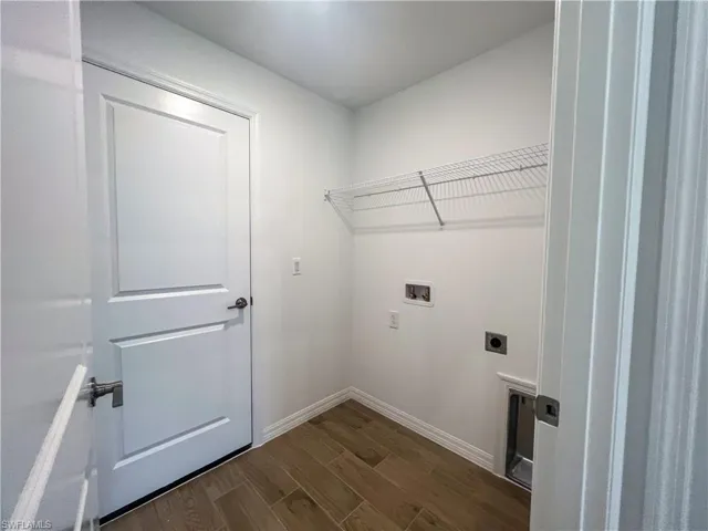 Washroom with wood tiled floors, hookup for a washing machine, and electric dryer hookup