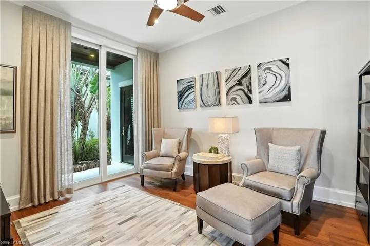 Sitting room featuring wood finished floors and ceiling fan