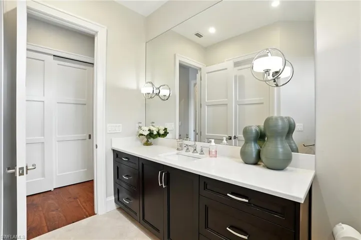 Bathroom with vanity, recessed lighting, and light wood finished floors