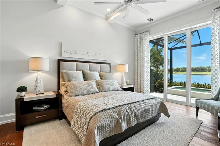 Bedroom with wood finished floors, a water view, access to exterior, ornamental molding, and ceiling fan
