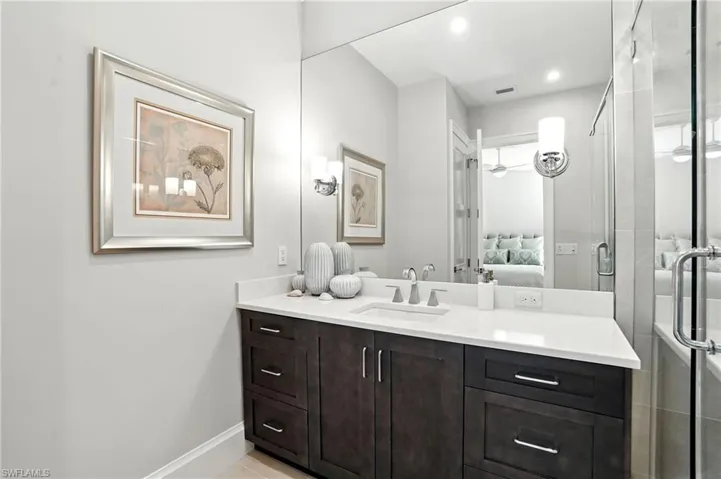 Ensuite bathroom featuring vanity and a stall shower