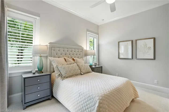 Bedroom featuring ornamental molding, carpet flooring, and ceiling fan