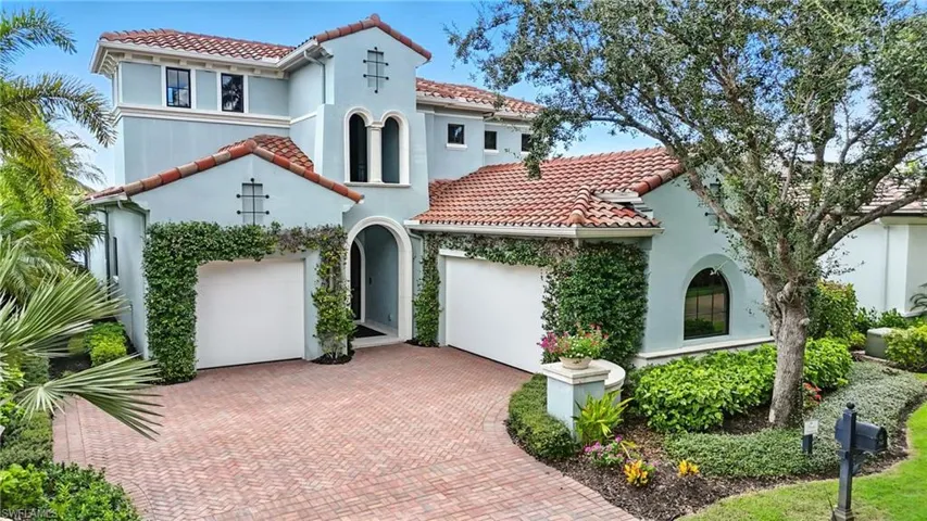 Mediterranean / spanish house featuring stucco siding, a tile roof, and decorative driveway
