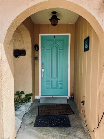 Property entrance with stucco siding