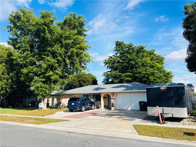 View of building exterior with a garage and concrete driveway