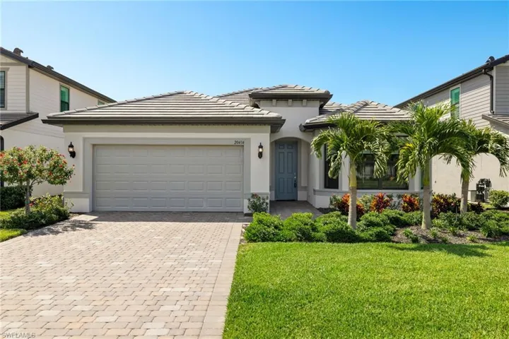 View of front of home featuring a garage and a front yard