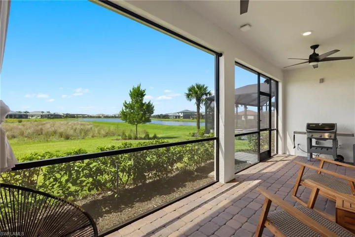 Sunroom / solarium featuring a water view and ceiling fan