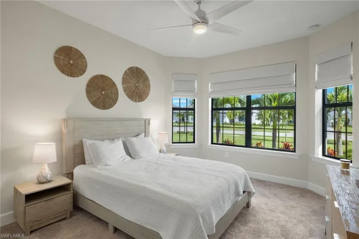 Bedroom with light carpet and ceiling fan