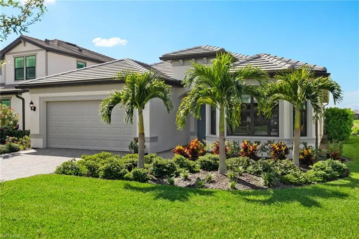 View of front facade with a front yard and a garage
