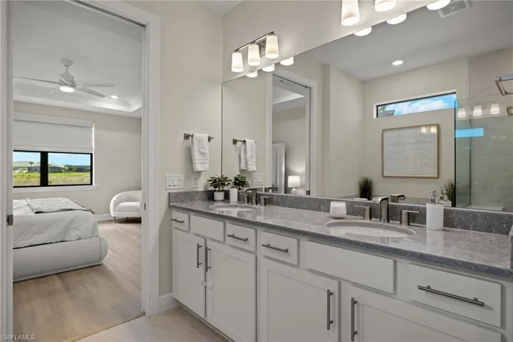 Bathroom featuring a shower, vanity, ceiling fan, and hardwood / wood-style flooring