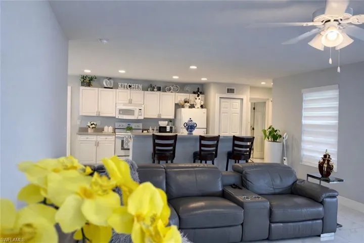 Living room featuring a ceiling fan and recessed lighting