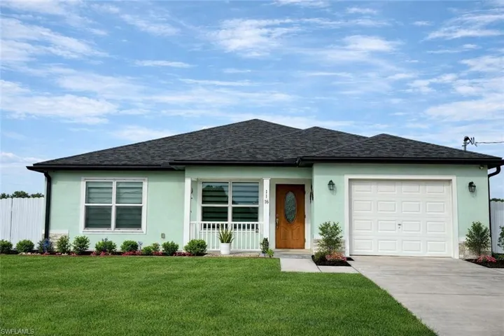 Single story home featuring a garage, stucco siding, concrete driveway, and a shingled roof