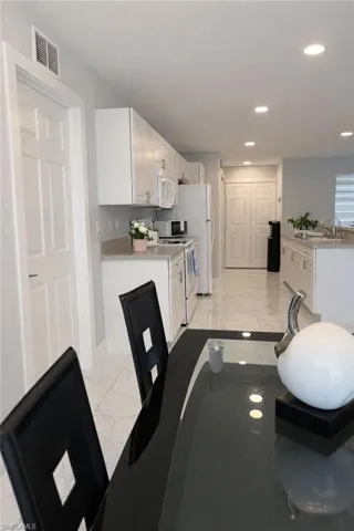 Dining room featuring light marble finish flooring and recessed lighting