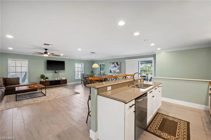 Kitchen featuring white cabinets, plenty of natural light, dishwasher, and sink