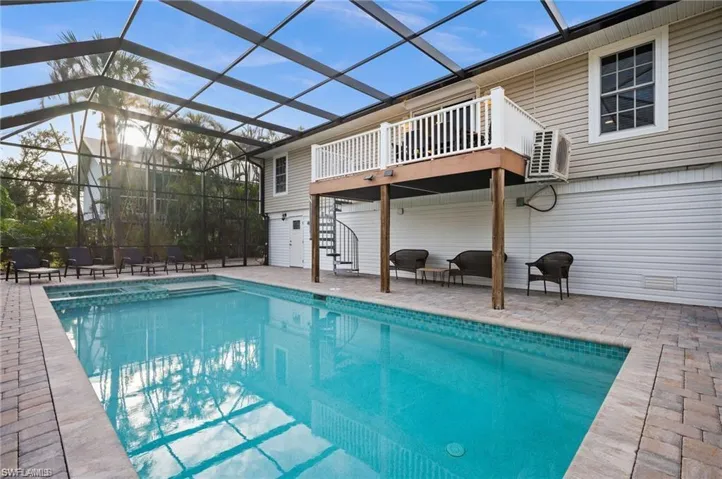 View of swimming pool featuring a patio and a lanai