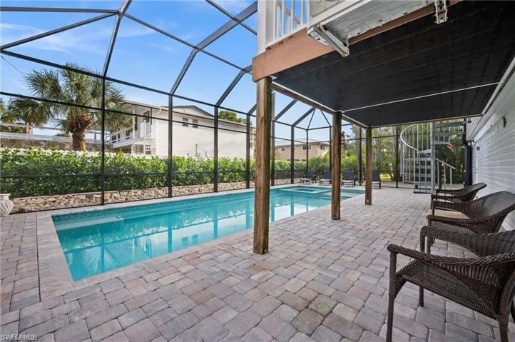View of pool with a lanai and a patio area