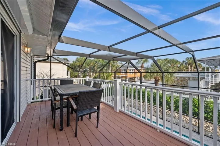 Deck featuring a water view and glass enclosure