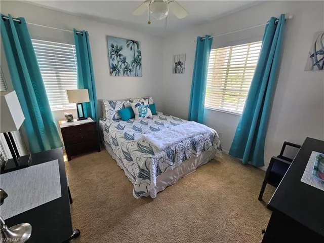 Bedroom with carpet and ceiling fan