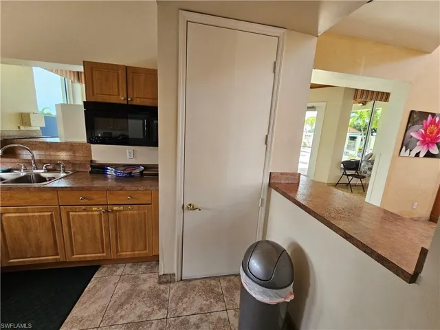 Community Kitchen with sink and light tile floors