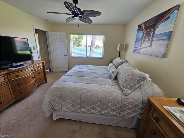 Bedroom featuring light carpet and ceiling fan