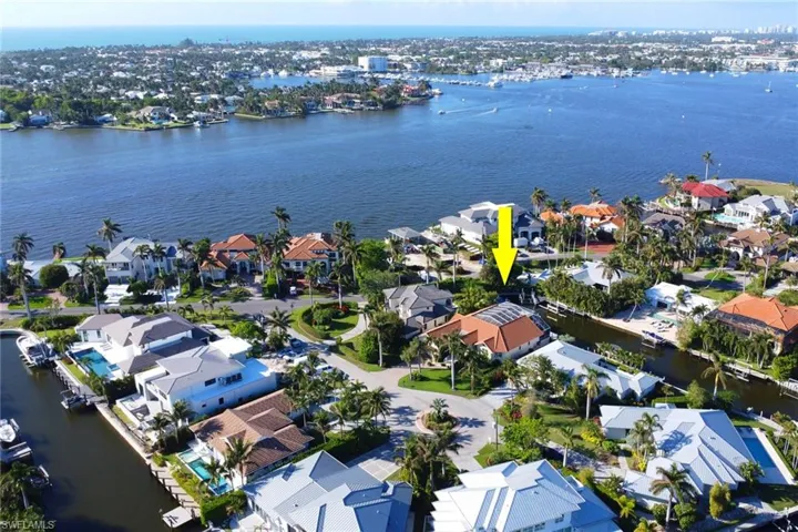 Aerial perspective of suburban area with a nearby body of water