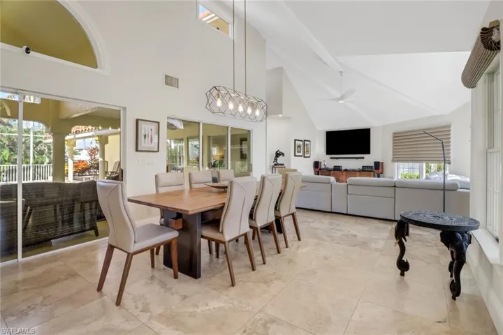 Dining room featuring a high ceiling and ceiling fan