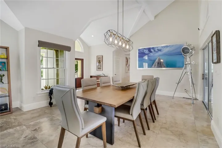Dining space featuring high vaulted ceiling and recessed lighting