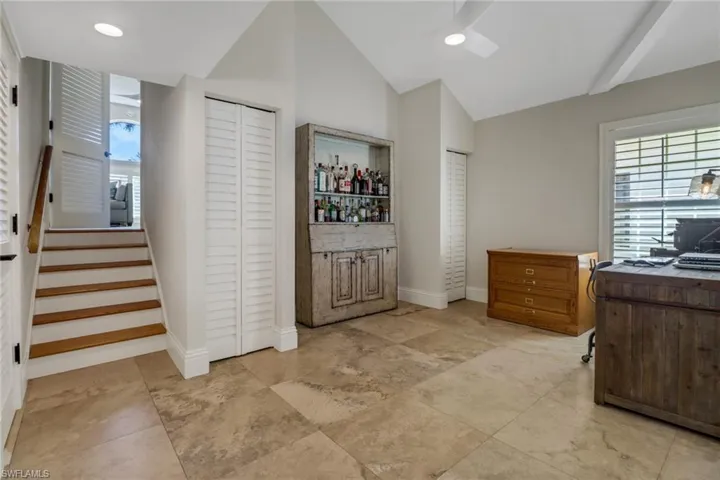 Office space featuring lofted ceiling, recessed lighting, and a ceiling fan