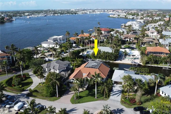Aerial perspective of suburban area with a nearby body of water