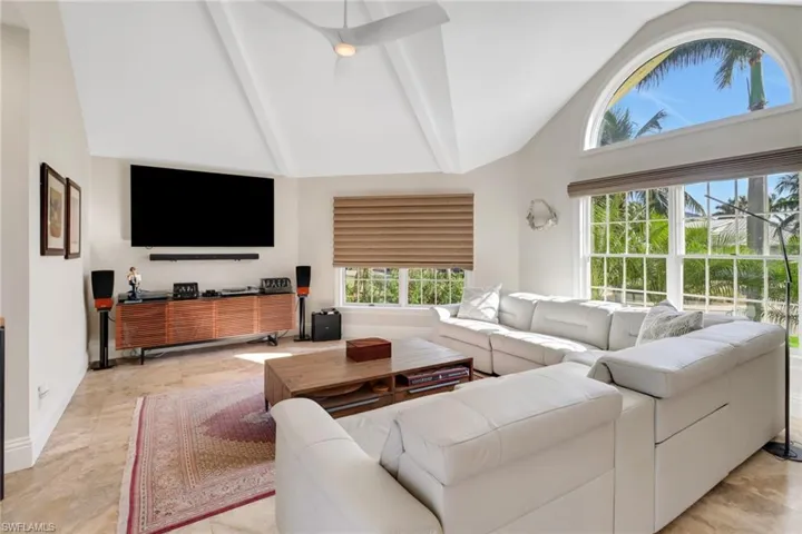 Living room with high vaulted ceiling and beamed ceiling