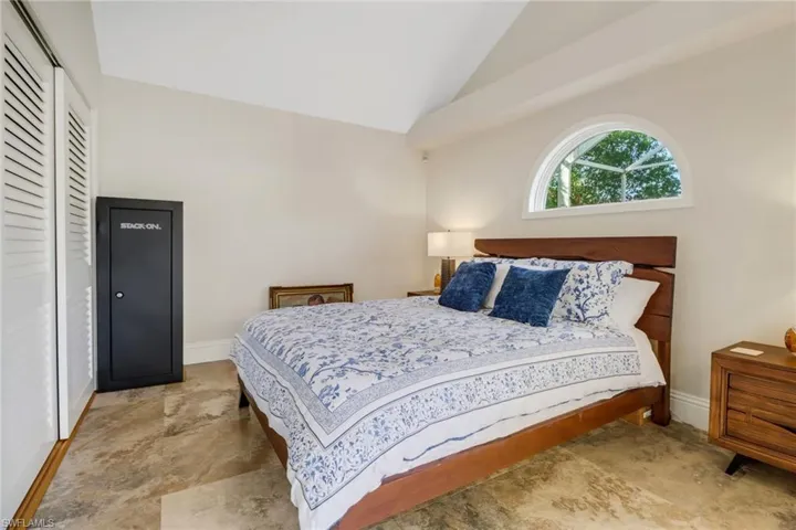 Bedroom featuring a closet and high vaulted ceiling