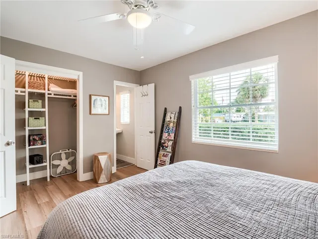 Bedroom with a closet, light wood-type flooring, and ceiling fan