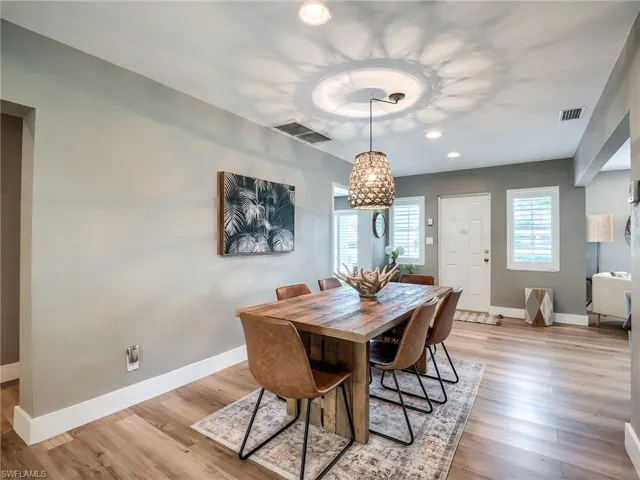 Dining room featuring a notable chandelier and light hardwood / wood-style flooring