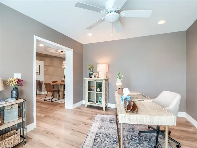 Office with ceiling fan and light wood-type flooring