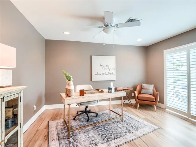 Office with ceiling fan and light wood-type flooring