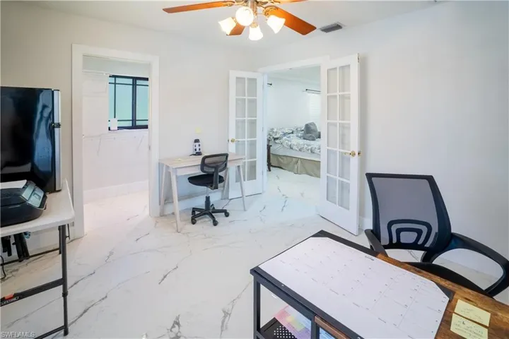 Office area featuring french doors and ceiling fan
