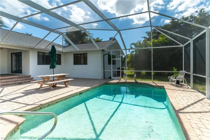View of pool with a lanai and a patio